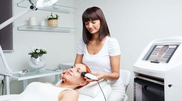 An expert conducts a skin rejuvenation session with an instrument